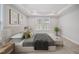 The main bedroom features neutral colors, tray ceiling, and large window at 212 War Admiral Dr, Clayton, NC 27520