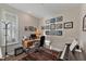 Home office with built-in desk and a wall of framed photos at 212 War Admiral Dr, Clayton, NC 27520