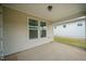 Covered screened-in porch with concrete flooring, ceiling light, and view of the backyard and neighboring home at 212 War Admiral Dr, Clayton, NC 27520
