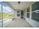 View from screened-in porch looking into backyard and into the home featuring an open door into the kitchen at 212 War Admiral Dr, Clayton, NC 27520