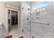 Large walk-in shower with marble tile and glass enclosure at 212 War Admiral Dr, Clayton, NC 27520