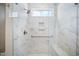 A tiled shower features a shower head, a window, and a built in niche at 212 War Admiral Dr, Clayton, NC 27520