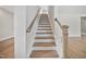 A staircase with white risers and wood treads leads to the upper level at 212 War Admiral Dr, Clayton, NC 27520