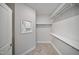 Empty walk-in closet with multiple storage shelves and hanging rods at 212 War Admiral Dr, Clayton, NC 27520