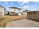 Backyard showcasing a lawn and a partial patio view with surrounding houses and a fence at 2321 Turtle Point Dr, Raleigh, NC 27604