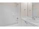 Bright bathroom featuring a tub and shower combination, sleek white vanity, and ample lighting at 2321 Turtle Point Dr, Raleigh, NC 27604