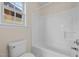 Bathroom features a tub and shower combination with a window for natural light above the toilet at 2321 Turtle Point Dr, Raleigh, NC 27604