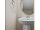Close-up of a half-bathroom featuring a pedestal sink and an oval mirror at 2321 Turtle Point Dr, Raleigh, NC 27604