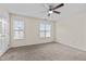 Spacious bedroom with neutral carpet, ceiling fan, and natural light from two windows at 2321 Turtle Point Dr, Raleigh, NC 27604