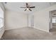 Carpeted bedroom with a ceiling fan and view of attached bathroom at 2321 Turtle Point Dr, Raleigh, NC 27604