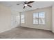 Carpeted bedroom with closet doors and two windows with natural light at 2321 Turtle Point Dr, Raleigh, NC 27604
