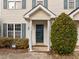 This is an exterior view of a townhome with a close up of the front door area and nice landscaping at 2321 Turtle Point Dr, Raleigh, NC 27604