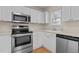 Close up of a kitchen featuring stainless steel appliances and white cabinetry at 2321 Turtle Point Dr, Raleigh, NC 27604