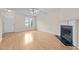 Living room with hardwood floors, fireplace, and ceiling fan at 2321 Turtle Point Dr, Raleigh, NC 27604