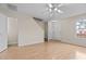 Spacious living room with a ceiling fan, hardwood floors and stairs leading to the second floor at 2321 Turtle Point Dr, Raleigh, NC 27604