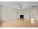 Living room with hardwood floors, fireplace, and ceiling fan at 2321 Turtle Point Dr, Raleigh, NC 27604