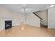 Open living room featuring a fireplace and hardwood floors leading to the stairs and dining room at 2321 Turtle Point Dr, Raleigh, NC 27604