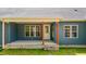 Inviting back porch with warm wood pillars, neutral-colored siding, and a concrete base, adding charm and relaxation at 260 Ellington Rd, Graham, NC 27253