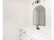 Modern bathroom featuring a quartz countertop, black fixtures, and an arched mirror at 260 Ellington Rd, Graham, NC 27253