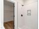 Bathroom featuring a tiled shower with black fixtures and a view of a walk-in closet with wire shelves at 260 Ellington Rd, Graham, NC 27253