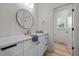 Bathroom featuring modern fixtures, white cabinets, and a vanity area at 260 Ellington Rd, Graham, NC 27253
