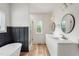 Bright bathroom with double vanity, tub, glass shower and matte gold accents at 260 Ellington Rd, Graham, NC 27253