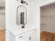 Bathroom with quartz countertop, black fixtures, arched mirror, and walk-in closet with wire shelving at 260 Ellington Rd, Graham, NC 27253