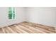 Bedroom with wood-look flooring, natural lighting, and fresh paint creating a serene atmosphere at 260 Ellington Rd, Graham, NC 27253
