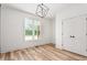 Well-lit bedroom with wood-look flooring, a window with natural light, and a double door closet at 260 Ellington Rd, Graham, NC 27253