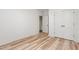 Bedroom featuring wood-look flooring, a window, and a closet with classic double doors at 260 Ellington Rd, Graham, NC 27253