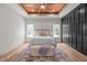 Serene bedroom with wood ceiling, built-in storage, a plush bed, and ample natural light from dual windows at 260 Ellington Rd, Graham, NC 27253
