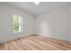 Bright bedroom with a large window offering natural light and hardwood floors at 260 Ellington Rd, Graham, NC 27253
