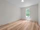 Bright bedroom with a large window offering natural light and hardwood floors at 260 Ellington Rd, Graham, NC 27253