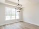 Sunlit dining space with modern lighting and large window at 260 Ellington Rd, Graham, NC 27253