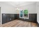Modern dining room with wainscoting and large window at 260 Ellington Rd, Graham, NC 27253