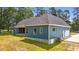 Side view of the home showcasing the blue siding, gray roof, and red porch columns at 260 Ellington Rd, Graham, NC 27253