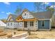 New construction home with a covered front porch, hardiplank siding and architectural shingle roof at 260 Ellington Rd, Graham, NC 27253