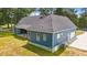 Aerial view of a blue home with a gray roof and manicured lawn at 260 Ellington Rd, Graham, NC 27253