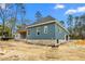 New home construction featuring brick foundation, blue siding, and new roof at 260 Ellington Rd, Graham, NC 27253