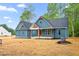 Attractive two-story home displays a blue exterior, complemented by a manicured yard and a partially-visible structure at 260 Ellington Rd, Graham, NC 27253