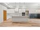 Contemporary white kitchen boasts a center island, stainless steel appliances, and elegant pendant lighting at 260 Ellington Rd, Graham, NC 27253