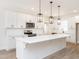 Bright kitchen featuring a center island with white cabinets, stainless appliances and subway tile backsplash at 260 Ellington Rd, Graham, NC 27253