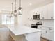 Kitchen featuring a large center island with white cabinets, quartz countertops and pendant lights at 260 Ellington Rd, Graham, NC 27253