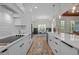 Modern kitchen with white cabinets, stainless steel appliances, and an island that connects to the dining area at 260 Ellington Rd, Graham, NC 27253