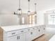 Bright open kitchen featuring a large center island, pendant lighting, and modern appliances at 260 Ellington Rd, Graham, NC 27253