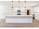 Bright kitchen featuring a center island with white cabinets, subway tile backsplash and modern lighting at 260 Ellington Rd, Graham, NC 27253
