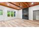 Spacious living room with hardwood floors, wood ceilings, and a modern fireplace at 260 Ellington Rd, Graham, NC 27253