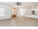 Open-concept living area with wood-look floors, kitchen view, and abundant natural light at 260 Ellington Rd, Graham, NC 27253