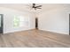 Spacious living room with wood-look flooring, white walls, and a ceiling fan at 260 Ellington Rd, Graham, NC 27253