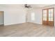 Open living room with wood-look flooring, a ceiling fan, and a view of the entryway at 260 Ellington Rd, Graham, NC 27253